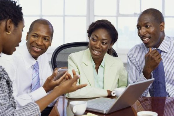 two businessmen and two businesswomen discussing in an office